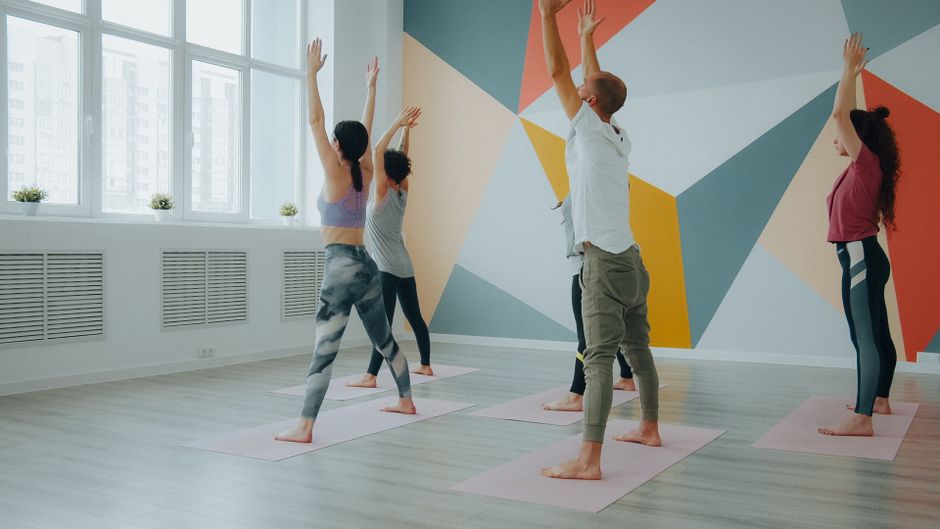 A teacher guiding a sun salutation sequence.